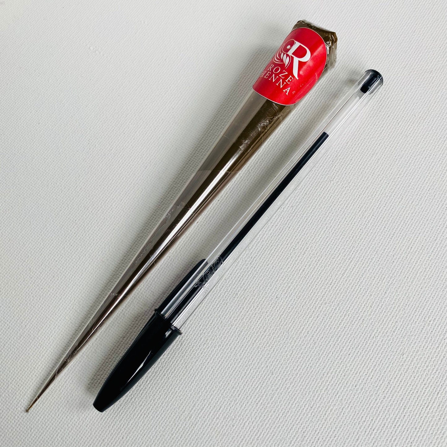 comparison of the henna cone next to a biro pen